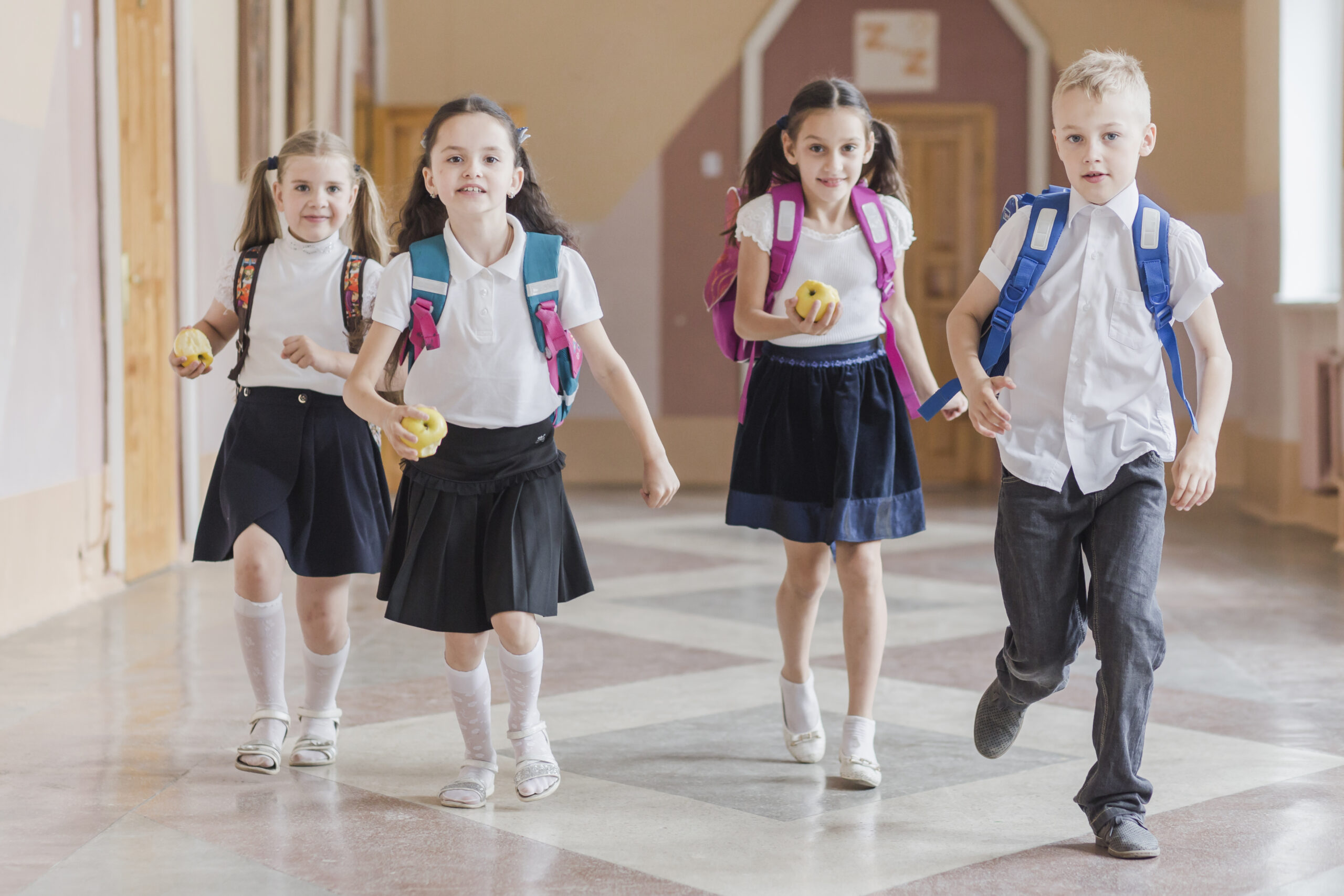 pupils running school hallway